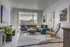 Modern living room with stylish decor, featuring a sleek sectional sofa, a chic armchair, and vibrant artwork on the walls. Bright and inviting space with a large window showcasing a beautiful view.