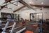 Contemporary fitness center with modern equipment, high ceilings, and stylish exposed ductwork for an invigorating workout experience.