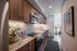 Elegant kitchen with modern wood cabinetry, sleek appliances, and a bright, open layout with natural light.