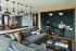 Modern apartment lounge featuring cozy seating, a stylish open kitchen, and a collaborative workspace atmosphere.