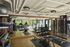 Modern fitness center with state-of-the-art equipment, large mirrors, and scenic views, perfect for an invigorating workout.