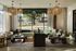 Elegant living room with large windows, green sofas, and stylish pendant lighting, offering a bright and modern space.
