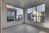 Bright and airy apartment corner with large windows offering stunning neighborhood views, featuring modern wooden flooring.