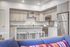 Contemporary kitchen with sleek stainless steel appliances, elegant granite countertops, and chic bar seating.