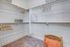 Spacious walk-in closet with ample hanging space, cozy carpeting, and stylish storage baskets.
