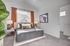 Bright and cozy bedroom with a stylish bed, plush pillows, and warm natural light streaming through the window.
