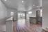 Bright and airy living space with modern wooden floors and a sleek open kitchen design.