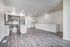 Modern open-concept kitchen and living area with sleek stainless steel appliances, elegant wooden flooring, and ample natural light.