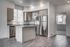 Bright and modern kitchen with stainless steel appliances, elegant wood cabinetry, and a spacious island countertop.
