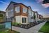 Modern townhouse complex with sleek design, large windows, and landscaped walkway at Hawthorne Residences.