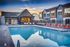 Charming apartment community with a modern pool area, surrounded by stylish architecture and comfortable lounge chairs, set against a beautiful sunset backdrop.