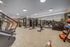 Modern fitness center featuring state-of-the-art gym equipment and spacious mirrored walls for an enhanced workout experience.