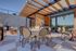 Chic rooftop patio with modern pergola, stylish seating, and a scenic view, perfect for dining and relaxation.