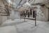 Modern and spacious secure bicycle storage area with industrial design and ample bike racks.