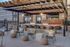 Chic outdoor patio with elegant seating, modern pergola, and ambient lighting, perfect for relaxing and entertaining.