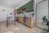 Contemporary kitchen with sleek cabinets, stainless steel appliances, and stylish breakfast bar, beautifully illuminated by natural light.