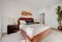 Inviting bedroom with a stylish wood headboard and modern bedside tables.