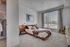 Contemporary bedroom with large window, stylish decor, and cozy atmosphere, perfect for relaxation.