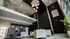Modern, spacious lobby with sleek white seating, elegant lighting, and artistic decor, offering a welcoming entrance to a luxurious apartment building.