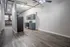 Modern loft-style kitchen with sleek appliances and rustic brick accents, featuring stylish cabinetry and open space concept.