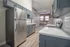 Chic urban kitchen featuring sleek stainless steel appliances, modern cabinetry, and exposed brick accents.