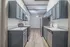 Modern kitchen with sleek gray cabinetry, stainless steel appliances, and elegant wood flooring, offering a stylish and functional space.