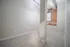Modern apartment room with cozy carpet flooring, exposed brick wall, and abundant natural light.
