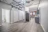 Modern loft-style apartment featuring an open floor plan with exposed brick, high ceilings, sleek kitchen cabinets, and contemporary lighting.
