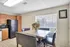 Bright kitchen with modern appliances, elegant wood cabinetry, and a chic marble dining table set for a cozy dining experience.