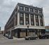 Charming urban apartment building with vintage architecture, offering potential retail space on the ground floor and convenient street parking.