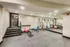 Modern fitness room with sleek gym equipment, mirrors for enhanced workouts, and ample space for exercise.