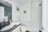Bright and modern bathroom featuring sleek tiles, elegant vanity, and stylish decor accents.