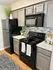 Modern kitchen featuring sleek gray cabinets, polished countertops, and contemporary appliances in a stylish design.