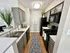 Modern kitchen with sleek gray cabinets, elegant countertops, stylish backsplash, and contemporary lighting, offering a chic and functional cooking space.
