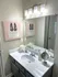 Chic bathroom with modern vanity, elegant lighting, and stylish decor creating a serene and inviting atmosphere.