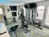 Modern home gym featuring sleek exercise equipment, mirrored walls, and a spacious, well-lit atmosphere for optimal workouts.