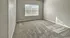 Bright and spacious bedroom with plush carpeting and a large window, perfect for natural light enthusiasts.