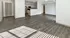 Spacious open-layout apartment featuring elegant dark wood flooring and a modern kitchen with stainless steel appliances.