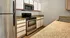 Modern kitchen with sleek stainless steel appliances, ample countertop space, and classic cabinetry for a stylish cooking experience.