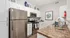 Charming modern kitchen with stainless steel appliances, sleek cabinetry, and elegant countertops, perfect for culinary enthusiasts.