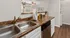 Modern kitchen with elegant granite countertops, dual sinks, and sleek appliances, perfect for a stylish and functional living space.