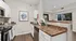 Chic modern kitchen with elegant granite countertops, stainless steel appliances, and natural light streaming through a large window.