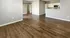 Inviting open floor plan with elegant wood flooring and a modern kitchen perfect for entertaining.