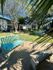 Charming outdoor space with turquoise benches and lush, green surroundings, perfect for relaxation and leisure.