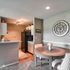 Inviting apartment interior featuring a cozy dining area and modern kitchen with stylish decor and soft lighting.