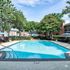 Inviting outdoor pool area surrounded by lush greenery and stylish seating, perfect for relaxation and enjoying sunny days.
