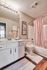 Charming bathroom with elegant vanity, pink accents, and inviting ambiance.