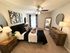 Tranquil bedroom oasis featuring elegant decor, cozy bedding, and natural light streaming through large windows.
