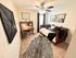 Charming home office featuring a cozy daybed, sophisticated wooden desk, and artistic decor.