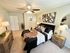 Inviting master bedroom with modern decor, plush bedding, and chic artwork, creating a cozy and stylish sanctuary.